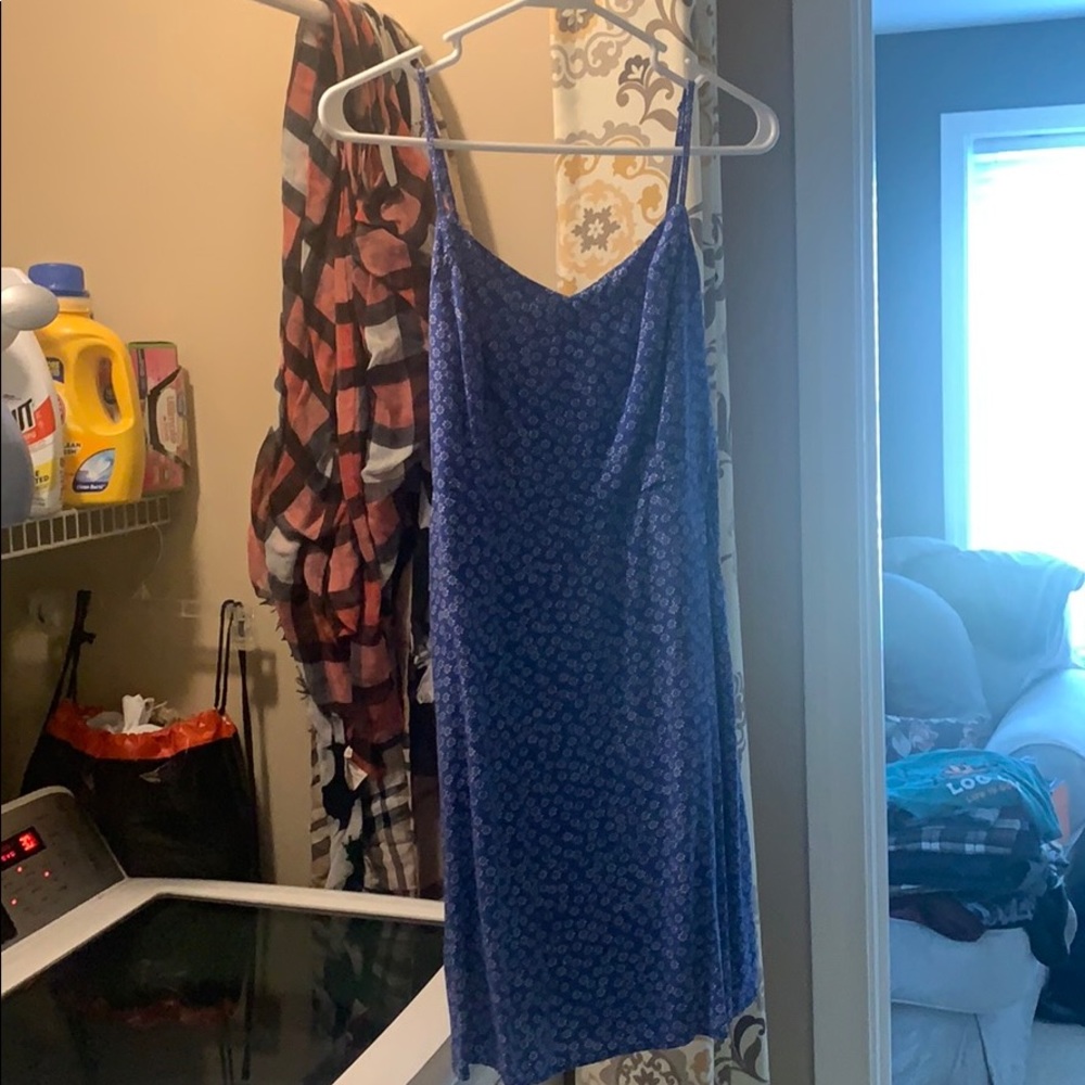 blue sun dress with white flowers has pockets